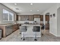 Bright kitchen featuring stainless steel appliances, granite countertops, and an island with barstool seating at 5232 Mountain Garland Ln, North Las Vegas, NV 89081