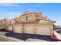 Exterior view of the condominium featuring a three-car garage, a tile roof, and a well maintained exterior at 5855 Valley Dr # 2130, North Las Vegas, NV 89031