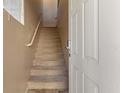 View of the carpeted stairway leading to the second level of the home, with a white handrail at 5855 Valley Dr # 2130, North Las Vegas, NV 89031