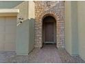 Inviting stone-framed front door with brick pathway and lush landscaping at 5953 Yellow Ridge Ave, Las Vegas, NV 89131
