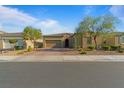 Attractive single-story home with desert landscaping, a brick driveway, and a two-car garage at 5953 Yellow Ridge Ave, Las Vegas, NV 89131