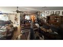 Spacious living room with various furniture, decor, and personal belongings throughout the space at 6271 Explorer Dr, Las Vegas, NV 89103