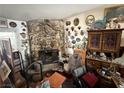 Living room featuring a stone fireplace, eclectic decorations, and various personal items at 6271 Explorer Dr, Las Vegas, NV 89103
