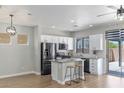 Bright kitchen with stainless appliances, granite counters, breakfast bar, and sliding doors to outdoor patio at 6525 Raven Hall St, North Las Vegas, NV 89084