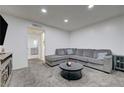 Comfortable living room featuring a large gray sectional and contemporary decor at 7066 Burcot Ave # 59, Las Vegas, NV 89156