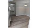 Cozy dining area with wood-look floors and a modern light fixture at 7426 Trudy Ln, Las Vegas, NV 89123