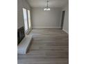 Bright living room with fireplace, recessed lights and light gray, wood-look floors at 7426 Trudy Ln, Las Vegas, NV 89123