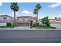 Exterior of two-story home with mature landscaping, a three car garage and tiled roof at 8620 Copper Mountain Ave, Las Vegas, NV 89129