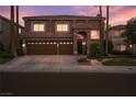 Two-story home with well-manicured lawn, a three car garage and tiled roof at 8620 Copper Mountain Ave, Las Vegas, NV 89129