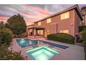 Beautiful backyard pool and spa with landscaped yard and covered patio at 8620 Copper Mountain Ave, Las Vegas, NV 89129