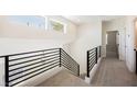 Upstairs landing with modern railing with lots of natural light at 9308 Pitching Wedge Dr, Las Vegas, NV 89134