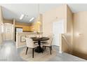 Dining area with a round table, four chairs, and a pendant light fixture at 9338 Square Dance Pl # 101, Las Vegas, NV 89178