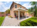 Spacious backyard featuring a covered patio, manicured lawn, and stylish hardscape at 9373 Wild Lariat Ave, Las Vegas, NV 89178