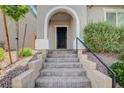 Inviting front entrance features stone steps leading to a covered doorway and lovely front landscaping at 10556 Sariah Skye Ave, Las Vegas, NV 89166