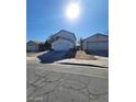 Two-story home featuring an attached two-car garage and separate garage on a sunny day at 1745 Starridge Way, Las Vegas, NV 89142