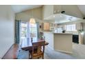 Dining area with bar seating, sliding door access to patio, and an adjacent kitchen at 2925 Wigwam Pkwy # 1124, Henderson, NV 89074