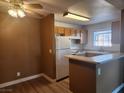 Cozy kitchen featuring wooden cabinets, white appliances, and a functional breakfast bar at 2986 Juniper Hills Blvd # 202, Las Vegas, NV 89142