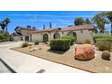 Charming home with stucco siding, desert landscaping, an attached two-car garage and tile roof at 3063 Chapala Dr, Las Vegas, NV 89120