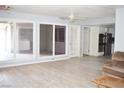 Open-concept living area with hardwood floors, ample natural light, and easy access to the kitchen at 3260 N Heritage Way, Las Vegas, NV 89121