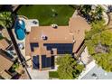 Captivating aerial shot of a home featuring solar panels, pool, patio and large backyard with mature landscaping at 3708 Lorraine Ln, Las Vegas, NV 89120