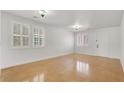 Bright living room featuring shuttered windows and concrete floors at 4036 W Bird Man Ln, North Las Vegas, NV 89084