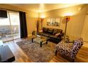 Stylish living area with comfortable seating, glass tables, and balcony access at 4200 S Valley View Blvd # 1035, Las Vegas, NV 89103