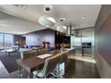 Open-concept kitchen with modern lighting, stainless steel appliances, and breakfast bar at 4381 W Flamingo Rd # 3221, Las Vegas, NV 89103