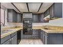 Well-maintained kitchen featuring dark cabinets, tile countertops, and modern appliances at 439 Columbia Ct, Boulder City, NV 89005