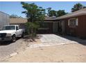Home's exterior showcasing a spacious yard, a white truck, and potential for outdoor activities at 4950 Burnham Ave, Las Vegas, NV 89119