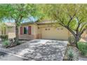Well-maintained one-story home with two-car garage, attractive desert landscaping, and mature shade trees at 5916 Sorto Lago St, North Las Vegas, NV 89081