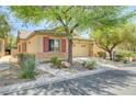 Lovely single-story home boasts desert landscaping, mature trees, an attached two-car garage, and great curb appeal at 5916 Sorto Lago St, North Las Vegas, NV 89081