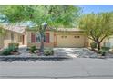Inviting single-story home with a manicured front yard, desert landscaping, and an attached two-car garage at 5916 Sorto Lago St, North Las Vegas, NV 89081