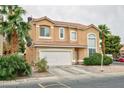 Two-story home with neutral paint, a two-car garage, desert landscaping, and mature palm trees at 6007 Turtle River Ave, Las Vegas, NV 89156