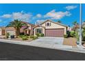 Inviting single-story home with a well-maintained front yard and a convenient two-car garage at 6035 Shadow Oak Dr, North Las Vegas, NV 89031