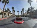 Neighborhood entrance with palm trees and Boulder Ranch signage on a sunny day at 6459 Rusticated Stone Ave # 103, Henderson, NV 89011
