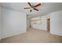 Spacious living room with carpet flooring, natural light, and an open doorway to the kitchen at 6955 N Durango Dr # 1093, Las Vegas, NV 89149