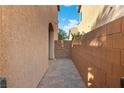 Property sideyard with brick pavers and a stucco wall at 7342 Brisbane Hills St, Las Vegas, NV 89166