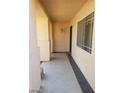 Covered entryway featuring tile floors and neutral colored walls leading to the front door at 7517 Apple Cider St, Las Vegas, NV 89131