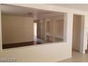 Open concept living room with light walls, tile floors and entry view at 7517 Apple Cider St, Las Vegas, NV 89131