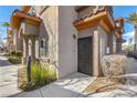 Charming front entrance with wrought iron door, lush landscaping, and well-maintained pathway at 7701 W Robindale Rd # 274, Las Vegas, NV 89113