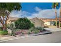 Inviting single-story home with landscaped front yard with desert plants and a two car garage at 819 Sandsprings St, Henderson, NV 89011
