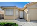 Charming single-story house with landscaped front yard and two car garage on a sunny day at 819 Sandsprings St, Henderson, NV 89011