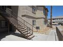 Condominium building exterior with stairs and walkway surrounded by desert landscaping on a sunny day at 8725 W Flamingo Rd # 216, Las Vegas, NV 89147
