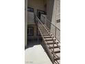 Exterior stairway showcasing metal railings and carpeted treads providing access to upper-level units at 8725 W Flamingo Rd # 216, Las Vegas, NV 89147