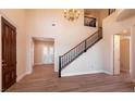 Grand foyer features high ceilings, staircase, and wood floors at 9001 Opus Dr, Las Vegas, NV 89117