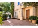 Charming front entrance with custom wood door and manicured landscaping at 9001 Opus Dr, Las Vegas, NV 89117