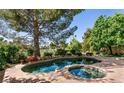 Inviting backyard pool and spa offer relaxation with golf course view at 9001 Opus Dr, Las Vegas, NV 89117