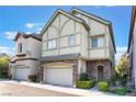 Two-story home featuring a stone-accented facade, attached two-car garage, and neat front yard landscaping at 9236 Whitekirk Pl, Las Vegas, NV 89145