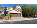 Charming stucco home with a two-car garage and manicured landscaping, offering great curb appeal at 9622 Staff Ln, Las Vegas, NV 89178