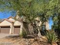 Beautiful two-story home with a tile roof, stucco exterior, and a spacious two-car garage at 9622 Staff Ln, Las Vegas, NV 89178